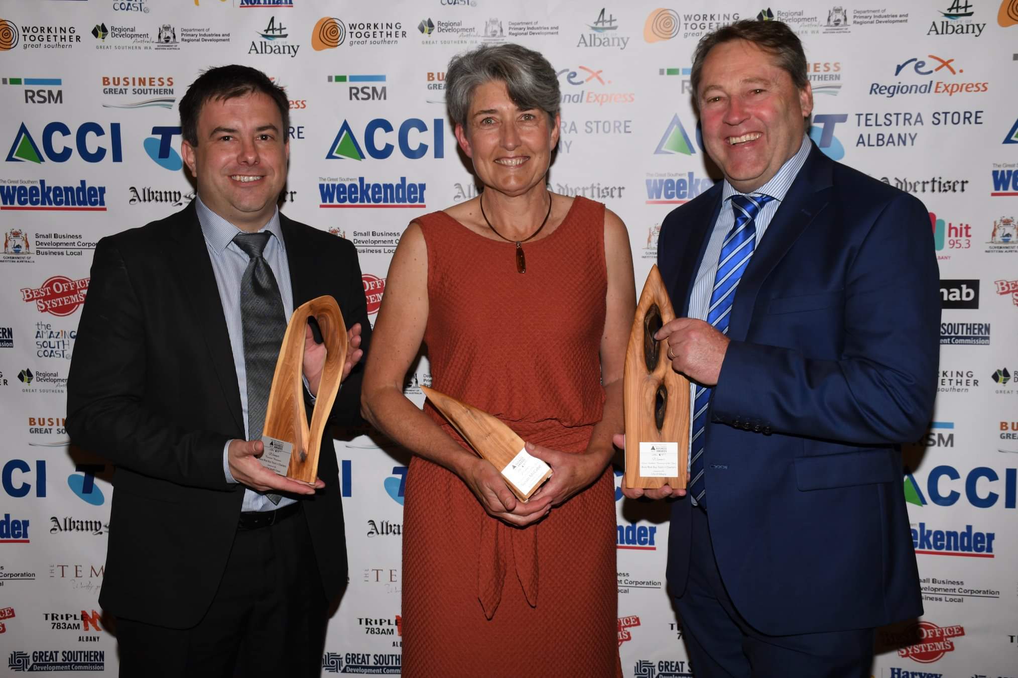 three people with awards